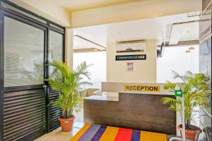an office lobby with plants and a reception desk at Super Townhouse OAK Regal Inn Near Sant Tukaram Nagar Metro Station in Pune +55 photos