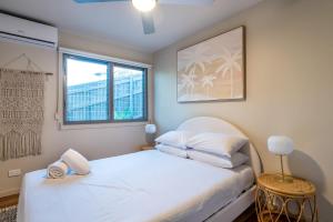a bedroom with a white bed and a window at The Majestic Coolum Ocean Views & Poolside Escape in Coolum Beach +39 photos