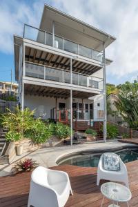 a large house with a swimming pool in front of it at The Majestic Coolum Ocean Views & Poolside Escape in Coolum Beach