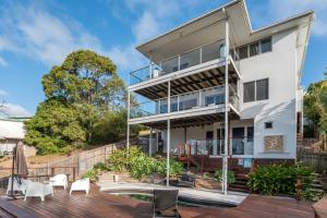 an exterior view of a white house with a deck at The Majestic Coolum Ocean Views & Poolside Escape in Coolum Beach