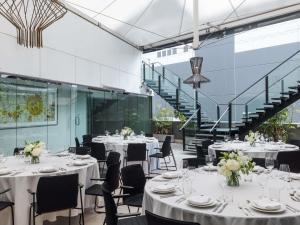 a banquet hall with tables and chairs and stairs at The Olsen Melbourne Art Series in Melbourne