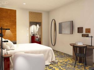 a bedroom with a white bed and a table and chairs at Hotel Lycium Debrecen - Handwritten Collection (October 2025) in Debrecen
