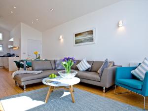 a living room with a couch and a table at Una Argentum 61 in Carbis Bay +17 photos