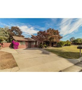 a house on a street with a driveway at New Unique Home Near Airport in Fresno +24 photos