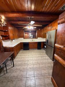 a large kitchen with wooden cabinets and a stainless steel refrigerator at New Unique Home Near Airport in Fresno