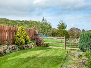 a wooden fence in a yard with a grass field at Tanglewood in Bugle