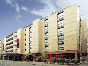 a large building on the corner of a street at Mercure Biel in Biel