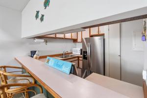 a kitchen with a counter with a no island sign on it at Kailua Bay Resort 4-305 condo in Kailua-Kona +23 photos