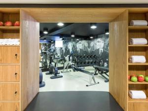 a fitness room with a gym with tread machines at INK Hotel Amsterdam - MGallery Collection in Amsterdam