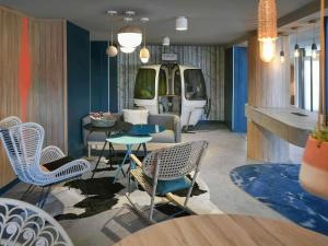 a room with chairs and a table and a van at Mercure Annemasse Porte De Genève in Gaillard