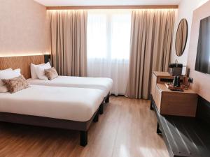 Ένα ή περισσότερα κρεβάτια σε δωμάτιο στο Novotel Montpellier