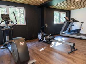 a gym with two exercise bikes and a treadmill at Novotel Rouen Sud Zenith Parc Expo in Saint-Étienne-du-Rouvray +89 photos