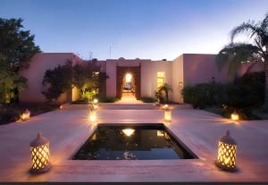 a house with a pool in the middle of a yard at Villa Serenity Marrakech in Châba
