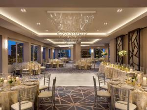 a banquet hall with tables and chairs and a chandelier at Swissotel Chicago in Chicago