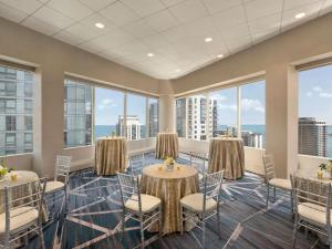 a large room with tables and chairs and windows at Swissotel Chicago in Chicago