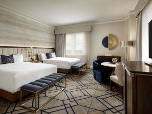 a hotel room with two beds and a desk at Fairmont Hotel Macdonald in Edmonton +131 photos