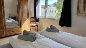 a bedroom with two beds and a large window at Haus Küstenzauber am Deich in Döse
