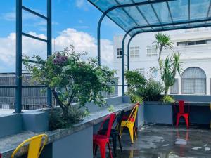 a patio with colorful chairs and plants at Hans Hotel in Da Nang