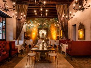 a dining room with a table and chairs at Sofitel Legend Santa Clara Cartagena in Cartagena de Indias