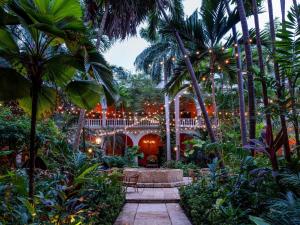 a garden with a pavilion and palm trees at Sofitel Legend Santa Clara Cartagena in Cartagena de Indias
