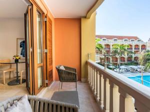 a balcony with a view of a pool at Sofitel Legend Santa Clara Cartagena in Cartagena de Indias