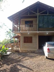 a house with a car parked in front of it at Morada Paraíso dos canyons in Praia Grande