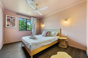 a bedroom with a bed and a ceiling fan at Roy and Estelles by Discover Stradbroke in Amity Point