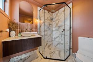 a bathroom with a shower and a sink at Roy and Estelles by Discover Stradbroke in Amity Point +22 photos