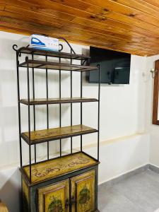 a shelf in a room with a wooden ceiling at Pousada Brisa da Montanha in Campos do Jordão