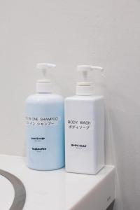 two bottles ofodorizers sitting on a bathroom counter at エイチビーイン in Hiroshima +16 photos