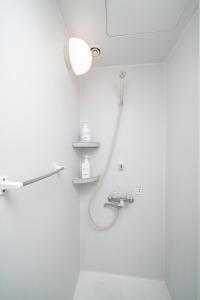 a bathroom with a shower and a mirror at エイチビーイン in Hiroshima
