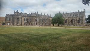 a large building with a grass field in front of it at Bishop bed and breakfast in Bishop Auckland
