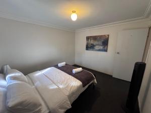 Un dormitorio con una cama con dos almohadas encima. en Apartments on Turf Unit 3, en Grafton