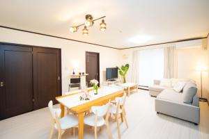 a living room with a dining table and a couch at Awaji Central in Kuruma - Vacation STAY 66482v in Awaji