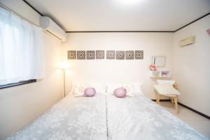 a bedroom with a large bed with purple pillows at Awaji Central in Kuruma - Vacation STAY 66482v in Awaji