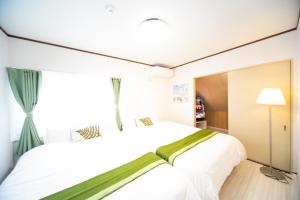 a bedroom with a large white bed and a window at Higashiomi - House - Vacation STAY 14173 in Higashiomi