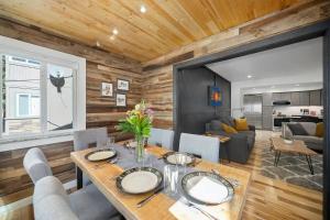 a dining room and living room with a wooden wall at Blue Bear - Perfect Mountain Getaway in Idaho Springs
