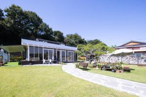 a house with a lawn in front of a building at Paran Garden in Damyang