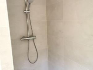 a shower with a shower head in a bathroom at Gîte de charme à Thiel-sur-Acolin : terrasse, grand terrain, barbecue et équipements modernes - FR-1-489-338 in Thiel-sur-Acolin +10 photos