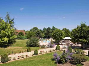a view of a garden with a swimming pool at ibis Styles Tours Sud in Chambray-lès-Tours
