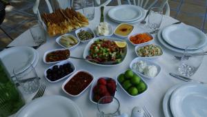 a white table topped with plates and bowls of food at River Side Hotel in Mingachevir