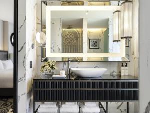 a bathroom with a sink and a mirror at Sofitel Adelaide in Adelaide