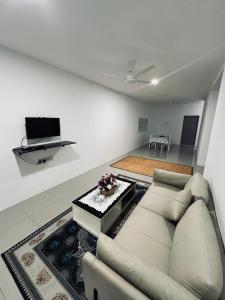 a living room with a couch and a table at Aristar D'Sejahtera Homestay 4 mu5lim in Bandar  Pusat Jengka