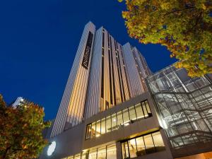a tall building at night with the lights on at Pullman Paris Montparnasse in Paris