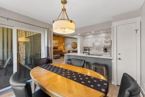 a kitchen and dining room with a wooden table and chairs at Lake Cliffe #305 Building A in Dillon