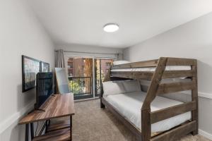 a bedroom with a bunk bed and a desk at Lake Cliffe #305 Building A in Dillon