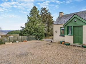 a house with a green door and a gravel driveway at 1 Bed in Dunning CA333 in Dunning