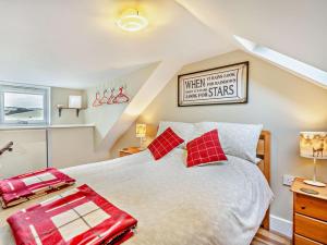 a bedroom with a large bed with red pillows at 1 Bed in Dunning CA333 in Dunning