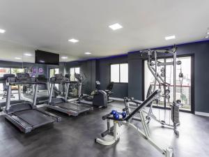 a gym with several tread machines in a room at Mercure Sao Paulo Pamplona in Sao Paulo