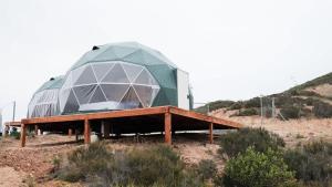 a building with a dome on top of a field at Wine Country Dome Getaway 1 in El Junco
